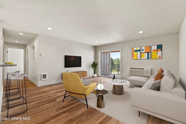 living room with recessed lighting, wood finished floors, and baseboards