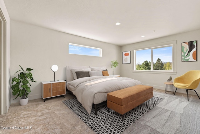 carpeted bedroom with recessed lighting, baseboards, and multiple windows