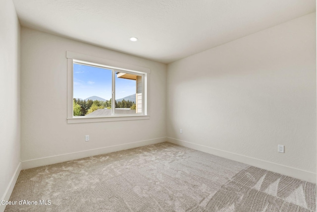 empty room with baseboards and carpet floors