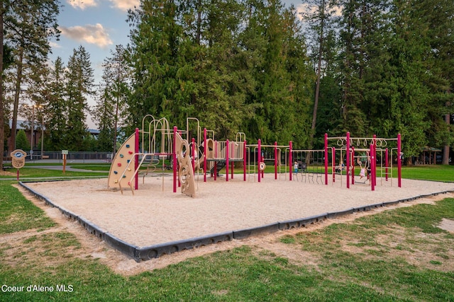 community jungle gym featuring a lawn