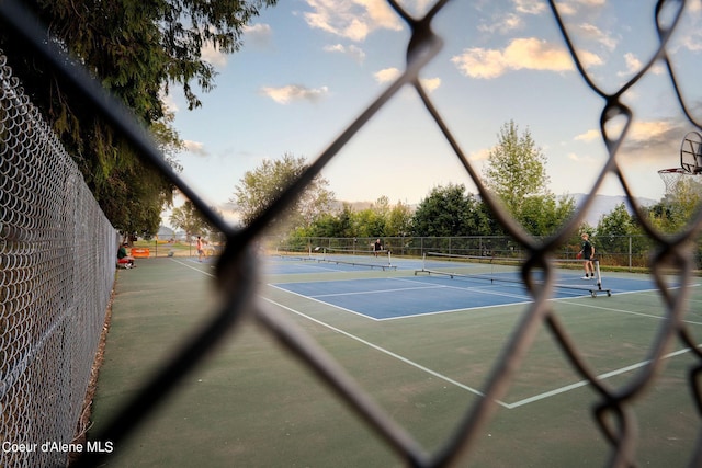 view of sport court featuring fence