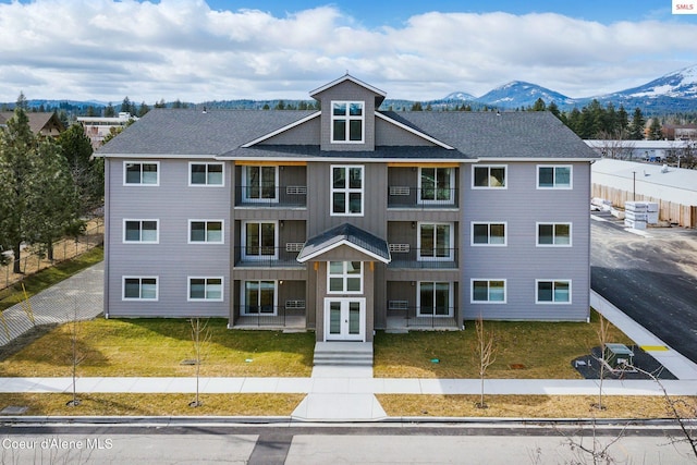 view of building exterior featuring fence and a mountain view