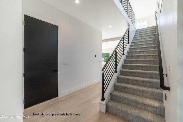 stairway featuring wood-type flooring