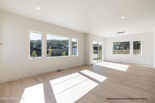 unfurnished room with light hardwood / wood-style floors