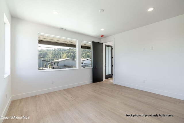 unfurnished room with light hardwood / wood-style floors