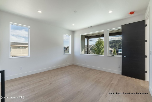 unfurnished room featuring light hardwood / wood-style flooring