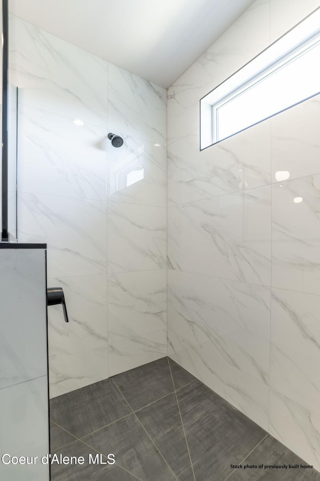 bathroom with tiled shower