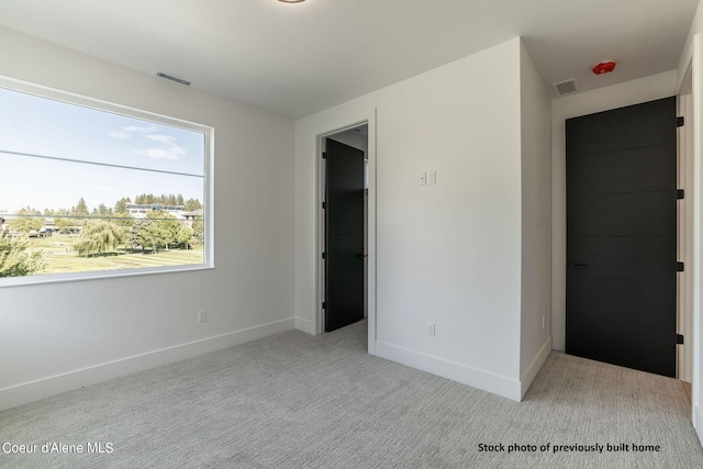 unfurnished bedroom featuring light colored carpet