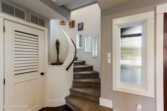 staircase with wood-type flooring