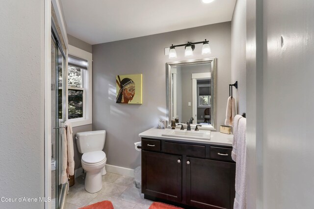 bathroom featuring tile patterned flooring, vanity, and toilet