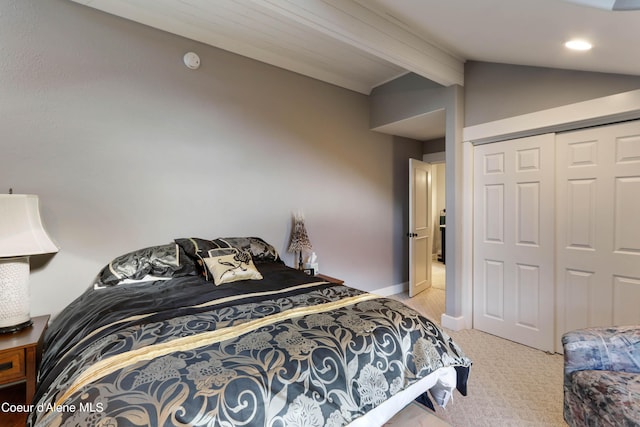 bedroom featuring a closet, light colored carpet, baseboards, and lofted ceiling with beams