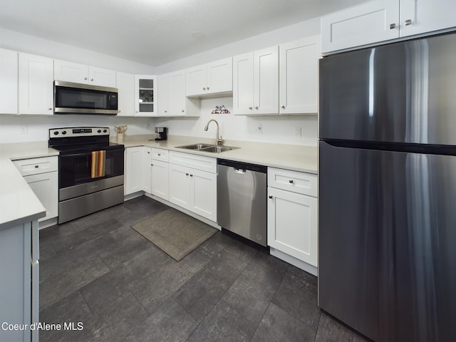 kitchen featuring sink, white cabinets, and appliances with stainless steel finishes