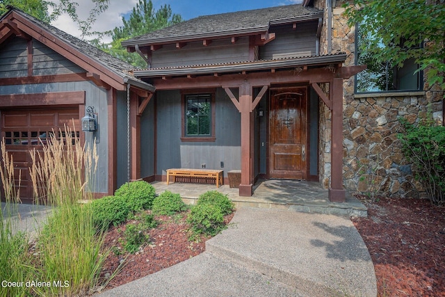 17021 S Citrine Dr, Coeur Dalene, ID 83814 - property entrance featuring an attached garage, a porch, and stone siding
