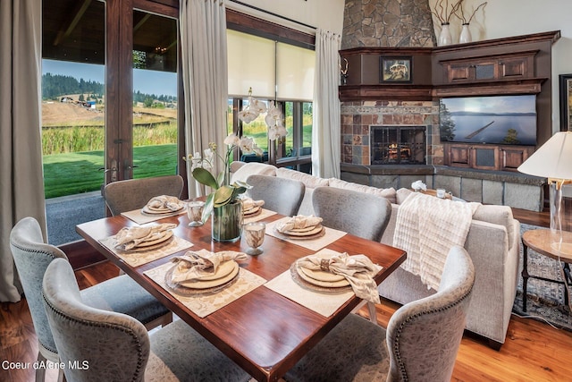 17021 S Citrine Dr, Coeur Dalene, ID 83814 - dining room with light wood-type flooring and a stone fireplace
