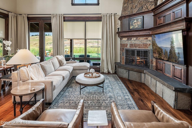 17021 S Citrine Dr, Coeur Dalene, ID 83814 - living area featuring a towering ceiling, wood finished floors, a large fireplace, and french doors
