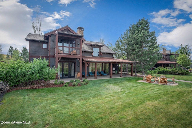 17021 S Citrine Dr, Coeur Dalene, ID 83814 - back of house with a lawn, a chimney, a balcony, and a patio