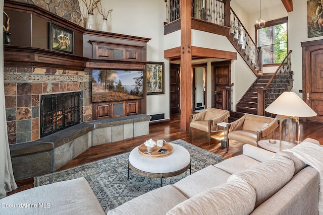 17021 S Citrine Dr, Coeur Dalene, ID 83814 - living area with stairway, wood finished floors, a chandelier, a towering ceiling, and a fireplace