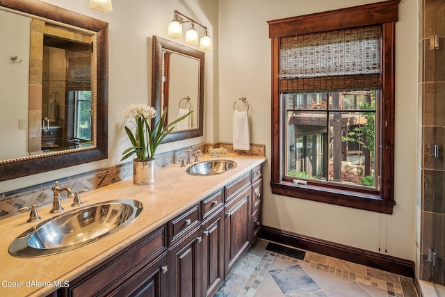 17021 S Citrine Dr, Coeur Dalene, ID 83814 - bathroom featuring baseboards, a shower with shower door, a sink, and double vanity