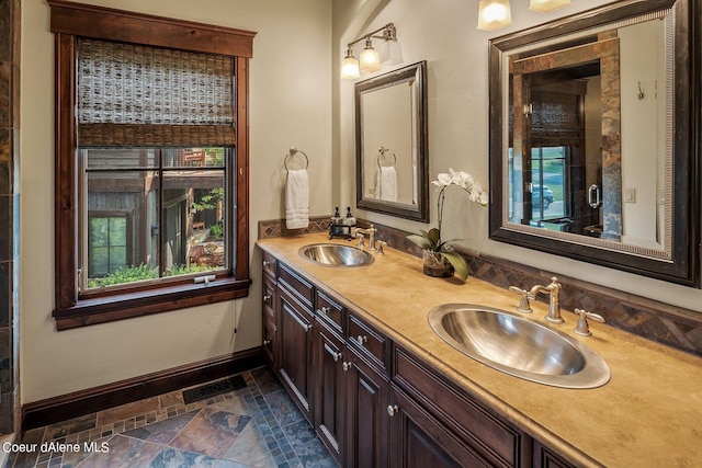 17021 S Citrine Dr, Coeur Dalene, ID 83814 - bathroom featuring stone finish floor, double vanity, visible vents, and a sink