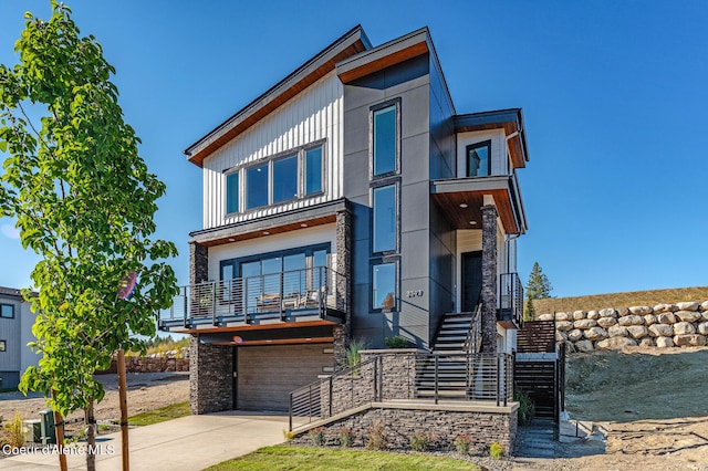 contemporary house with a balcony and a garage