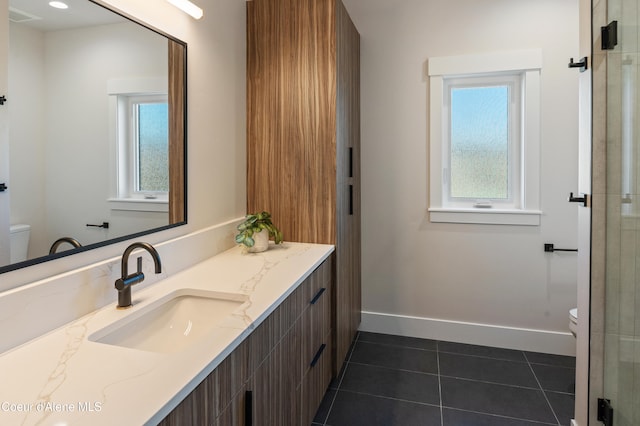 bathroom featuring a wealth of natural light, tile patterned floors, and toilet