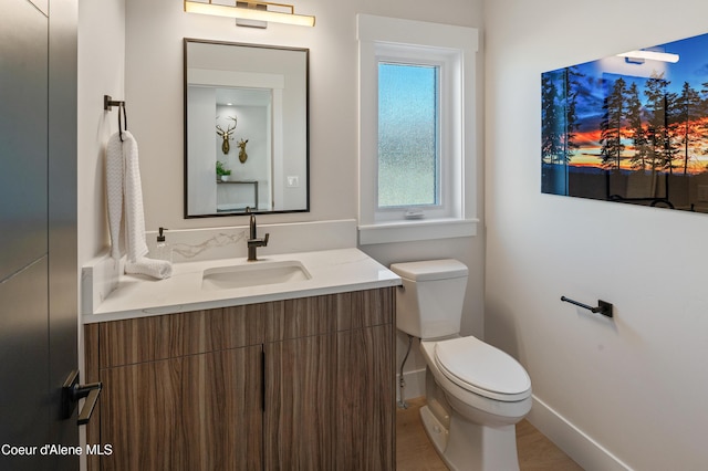 2747 W Lumber Ln, Coeur Dalene, ID 83814 - half bathroom featuring toilet, vanity, and baseboards