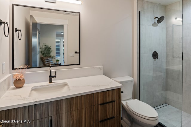 bathroom featuring vanity, toilet, and walk in shower