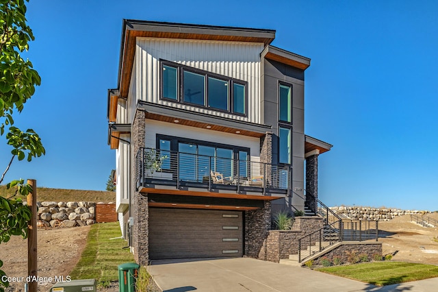 contemporary house featuring a balcony and a garage