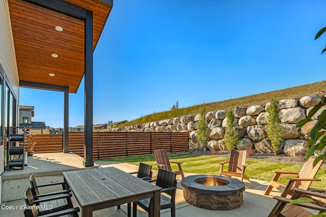 view of patio with a fire pit