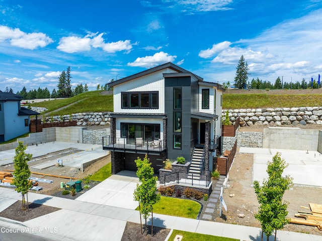 2747 W Lumber Ln, Coeur Dalene, ID 83814 - modern home featuring a garage, concrete driveway, and stairs