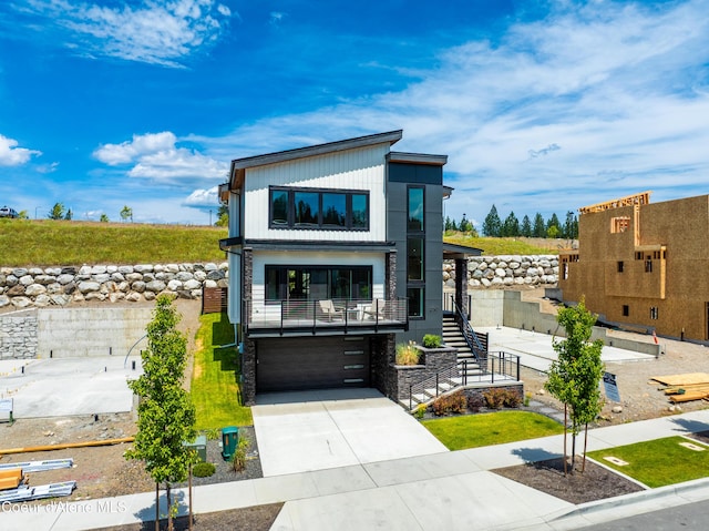 2747 W Lumber Ln, Coeur Dalene, ID 83814 - contemporary home with stairway, an attached garage, and concrete driveway