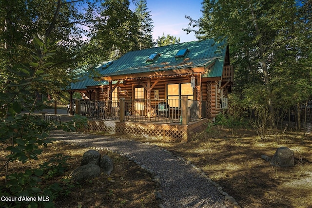 log home featuring a deck