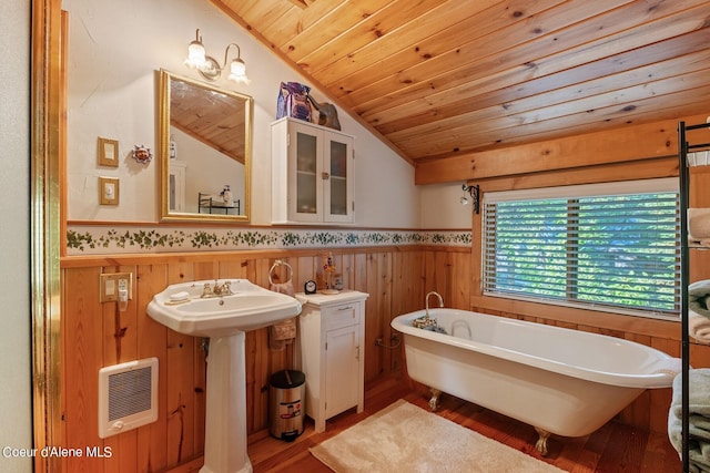 bathroom with lofted ceiling, a tub, wood-type flooring, heating unit, and wooden ceiling