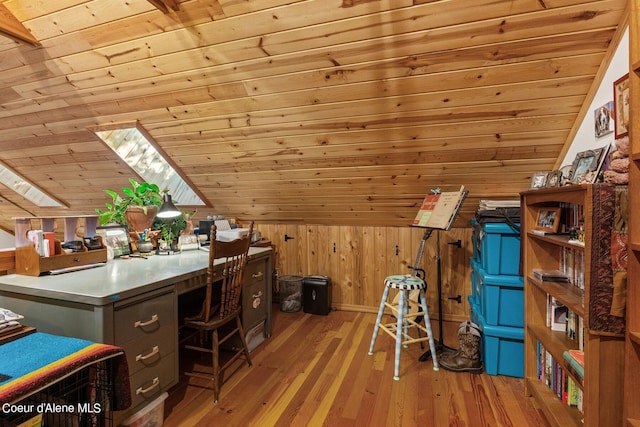 unfurnished office with lofted ceiling with skylight, wood walls, wooden ceiling, and light hardwood / wood-style flooring