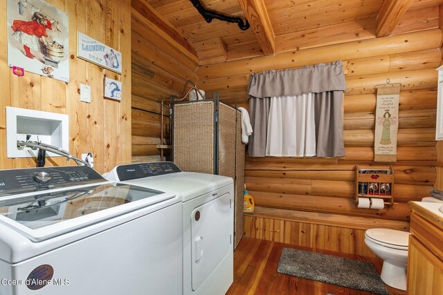 washroom with independent washer and dryer, wooden ceiling, rustic walls, and dark wood-type flooring