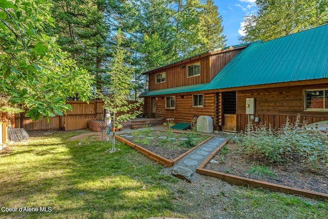 rear view of house featuring a yard