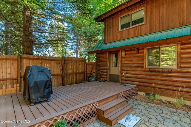 wooden terrace featuring a grill