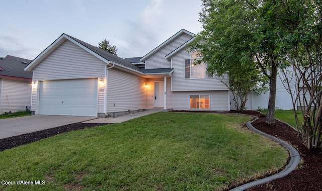 view of front of property featuring a garage and a front lawn