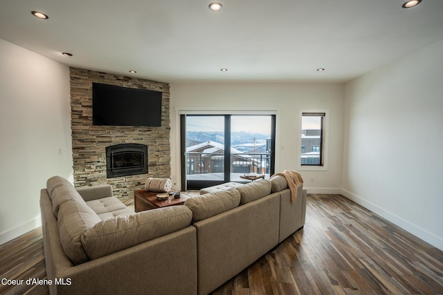 living area featuring a fireplace, recessed lighting, dark wood-style flooring, and baseboards