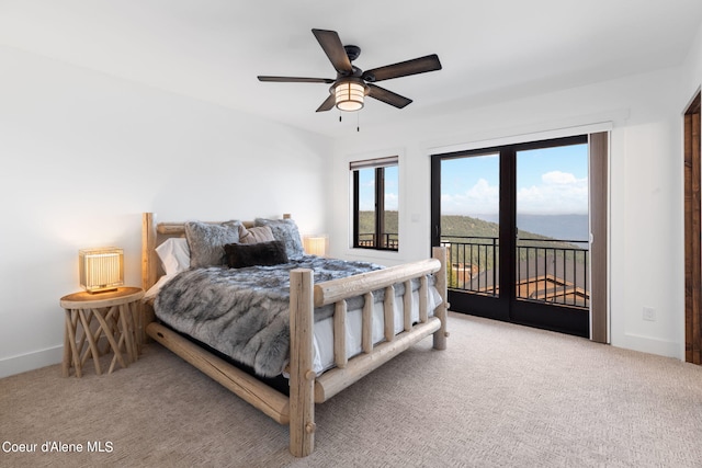 carpeted bedroom featuring access to exterior, a ceiling fan, and baseboards