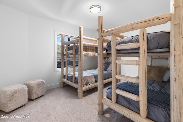 bedroom with carpet floors and baseboards