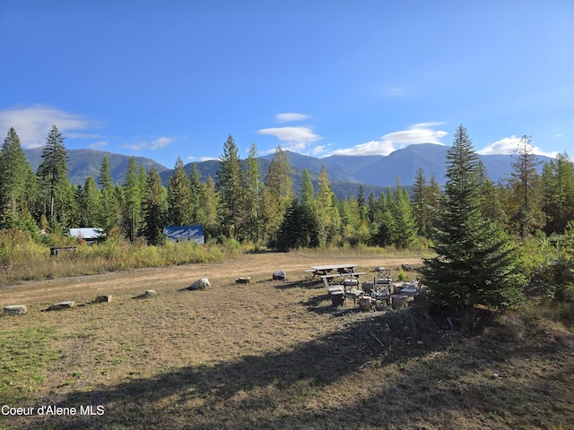 property view of mountains featuring a view of trees