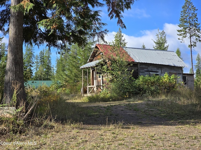 view of side of property featuring metal roof