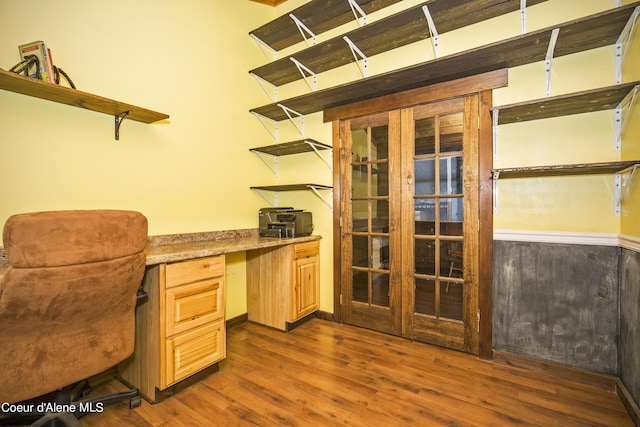 home office with built in study area and dark wood-style floors