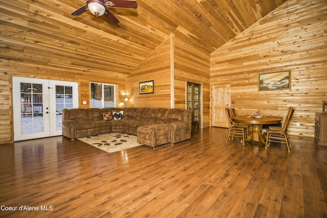 living room with wooden ceiling, high vaulted ceiling, french doors, and wood walls