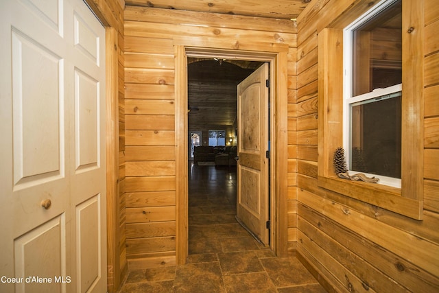 hallway featuring a sauna and wood walls