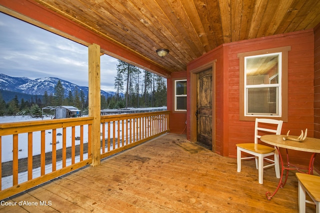 snow covered deck featuring a mountain view