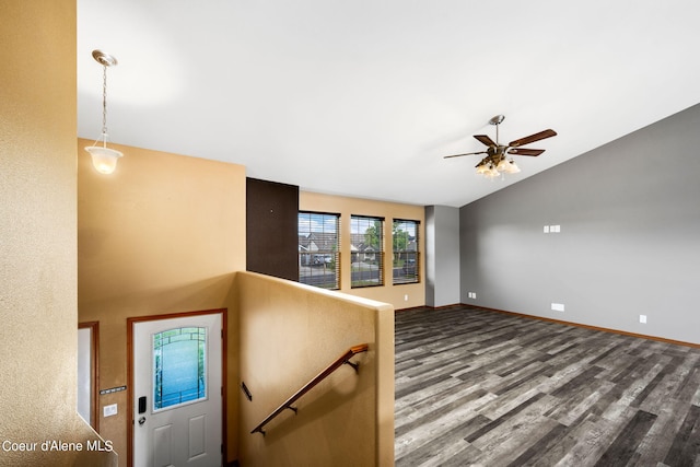 interior space with baseboards, dark wood-style flooring, ceiling fan, and lofted ceiling