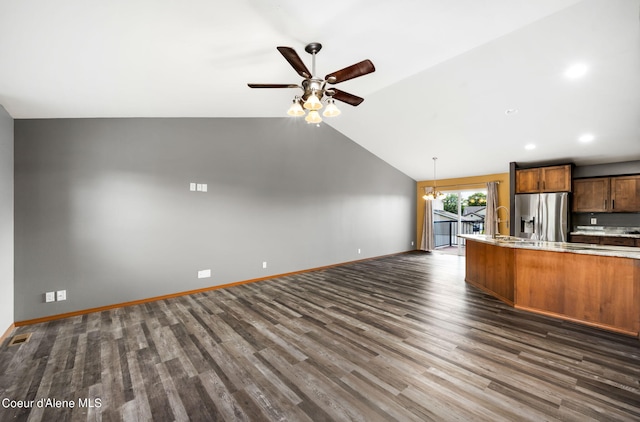 kitchen with stainless steel fridge with ice dispenser, ceiling fan with notable chandelier, lofted ceiling, hanging light fixtures, and dark hardwood / wood-style flooring