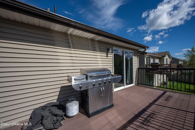 wooden terrace with a grill